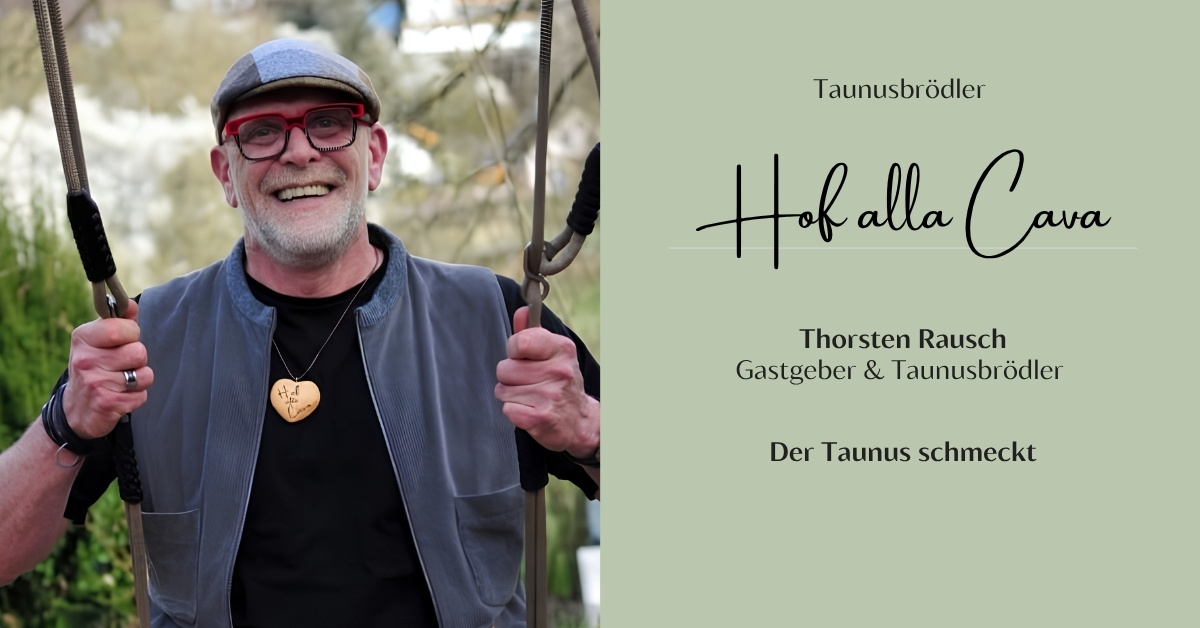 Thorsten Rausch, Gastgeber des Hof alla Cava und Taunusbrödler, sitzt lachend auf einer Schaukel und trägt eine Herz-Kette mit Hof-alla-Cava-Gravur